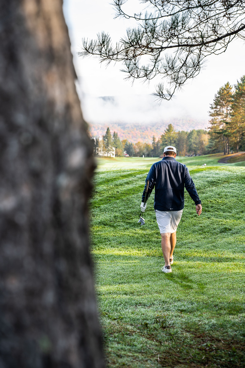 golfer walking on a golf course